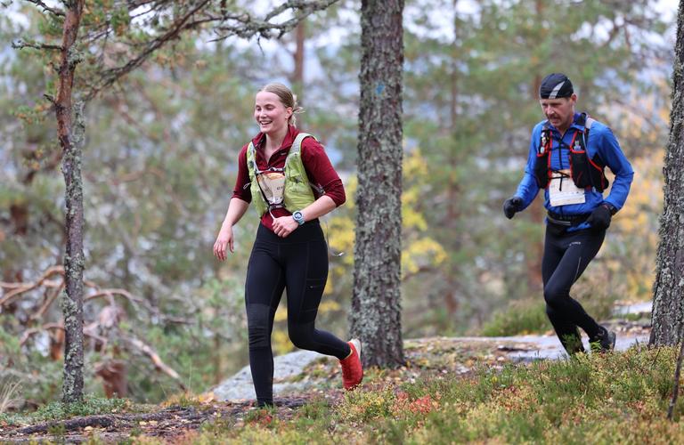 Vaarojen Extreme trail runners enjoying the diverse terrains of Koli National Park in autumn nature.